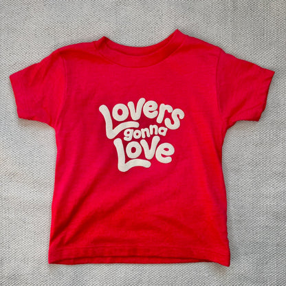 A kids size red hoodie that says Lovers Gonna Love