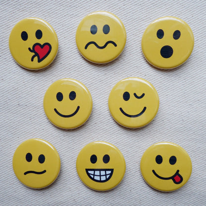 Detailed picture of small pin buttons with different emotional faces